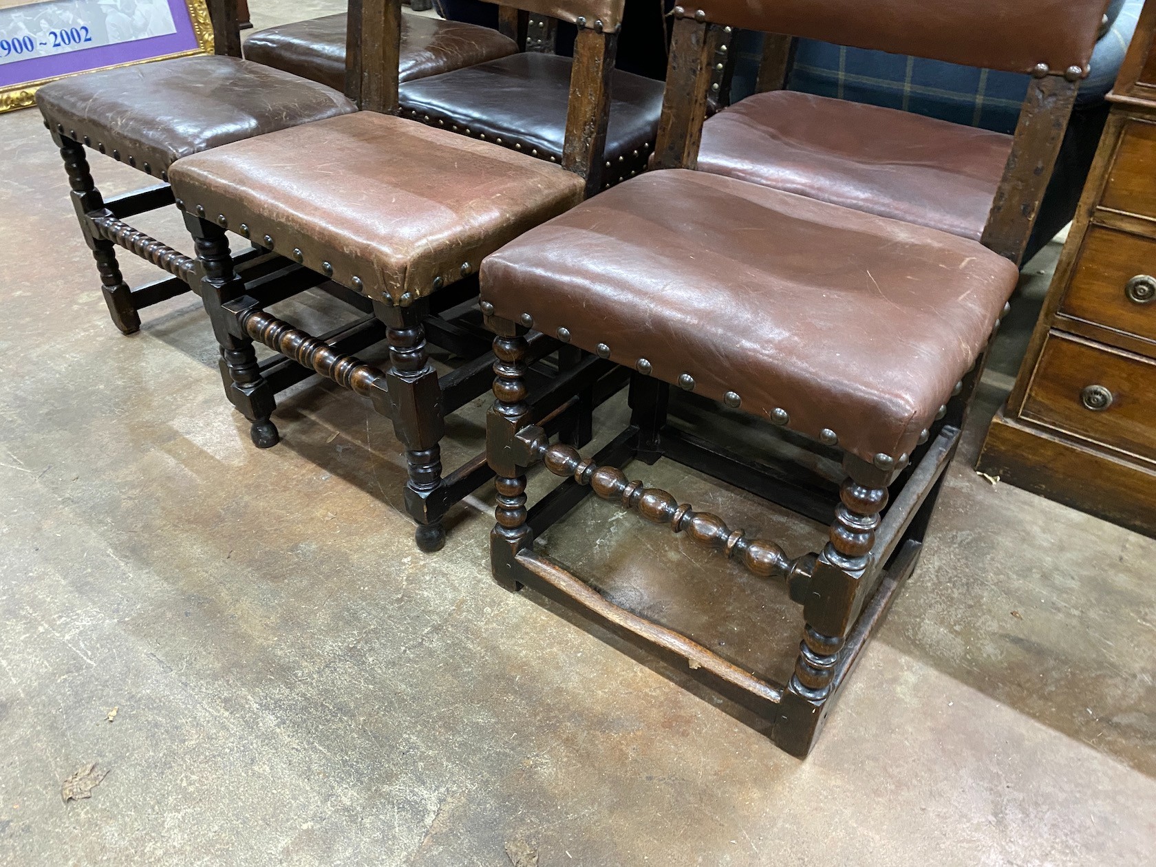 Six Cromwellian style oak and leather dining chairs